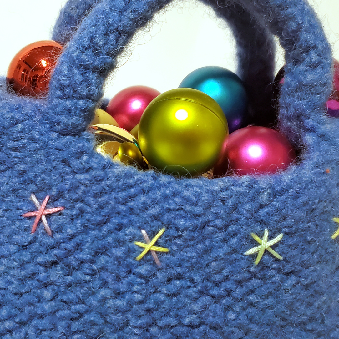 Detailaufnahme von bleuem Filztäschchen mit Sticksternen
